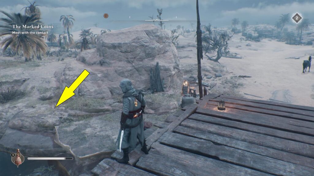 The Gift Enigma treasure sits by a large rock near the river.