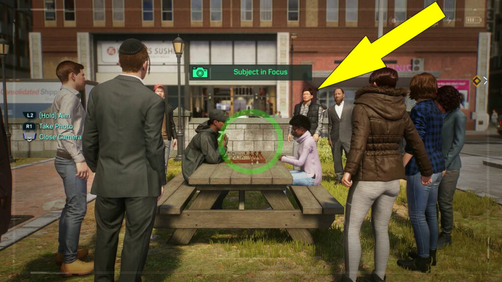 Take a picture of the people playing chess in the litlle park area.