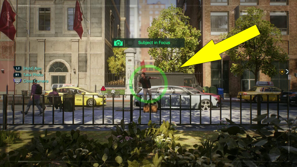 Take a picture of the man standing on a crate near the park's border.