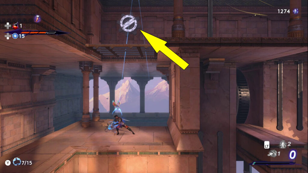 Aim and shoot at the second white gear wheel.